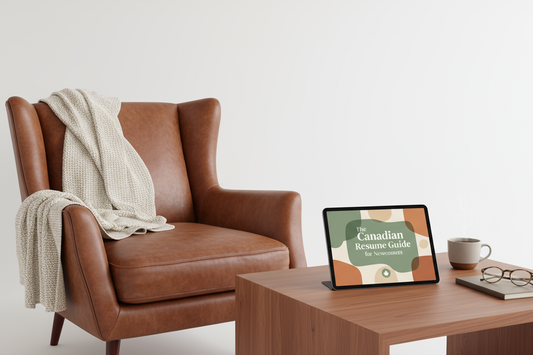 Brown leather armchair with a blanket draped over it, next to a wooden table with a tablet on a white background.